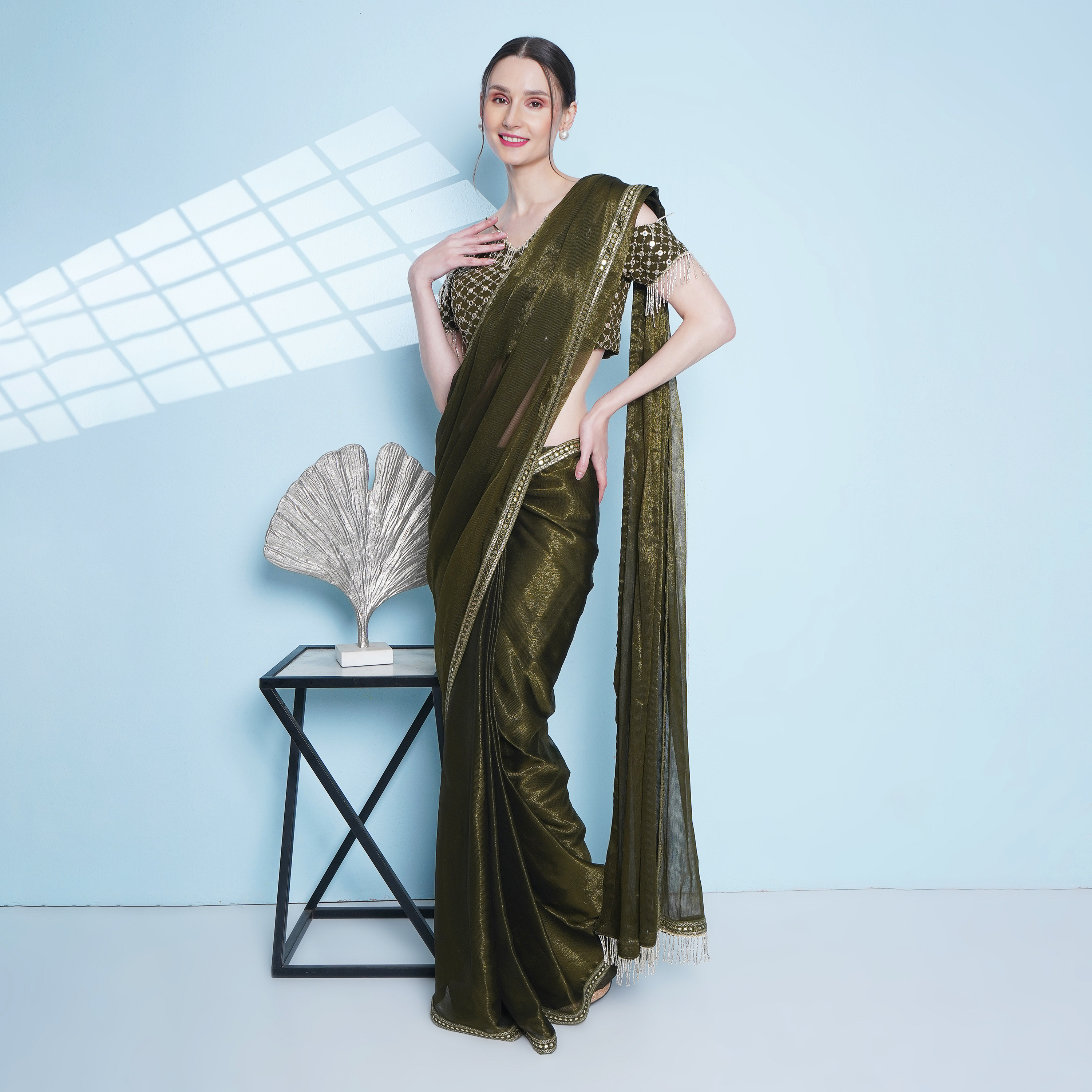 Olive sari drape worn with embellished corset blouse